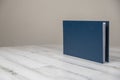 Navy blue leather album book - blank cover on isolated white wooden background Royalty Free Stock Photo