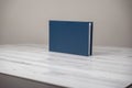 Navy blue leather album book - blank cover on isolated white wooden background Royalty Free Stock Photo