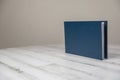 Navy blue leather album book - blank cover on isolated white wooden background Royalty Free Stock Photo