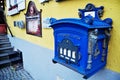 Navy blue mailbox on wall decoration furniture at outdoor of classic vintage retro building house at Pfunds village in evening