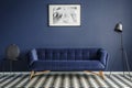 Navy blue room interior with comfortable plush couch in the midd