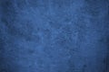 Navy blue rough background. Toned texture. Old scratched damaged wall surface. Blue concrete background