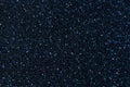 Navy blue sparkling background from small sequins, closeup. Brilliant shiny backdrop from textile. Royalty Free Stock Photo