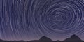 Navy blue stargaze background. Night sky spinning stars trail texture. Stargazing mountains silhouette backdrop. Night stars Royalty Free Stock Photo