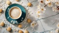 a navy cup of coffee paired with a few cookies, adorned with delicate sakura blossoms on the table, in a close-up shot.