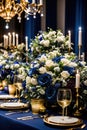 Navy and golden table setting, wedding planner\'s luxurious floral arrangement close-up