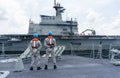 Navy sailors of HTMS Bhumibol Adulyadej FFG 471 stand on the deck waiting for refueling at sea with HTMS Chakri Naruebet CVH