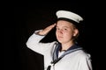 Navy seaman saluting on black Royalty Free Stock Photo