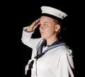 Navy seaman saluting on black