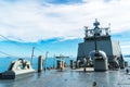 Navy ship sails in the sea show its bow including main gun.