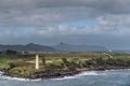Airplane lands past Ninini Point Lighthouse, Nawiliwili, Kauai, Hawaii, USA