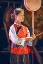 A Naxi woman performs in a theater, Lijiang, China