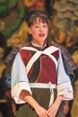 A Naxi woman performs in a theater, Lijiang, China