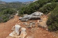 Broken statue lying on the ground. Called Kouros.  at Melanes traditional village in Naxos. Greece. Royalty Free Stock Photo