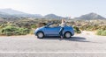 Naxos, Greece - May 2018: woman drives convertible blue car on mountain road Royalty Free Stock Photo