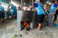 People making food on the wood stove at the Caxixis fair in Nazare, Bahia