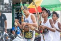 Group of capoeira practitioners walking towards the square