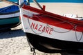 Nazare, Portugal - November 5, 2017: colorful traditional old wooden fishing boat on the beach of fishing village of Nazare . Royalty Free Stock Photo