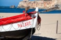 Colorful traditional old wooden fishing boat on the beach of fishing village of Nazare . Royalty Free Stock Photo