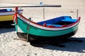 Nazare, Portugal - November 5, 2017: colorful traditional old wooden fishing boat on the beach of fishing village of Nazare . Royalty Free Stock Photo