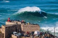 Nazare, Portugal, Surfer Riding Giant Wave in Front of Nazare Lighthouse