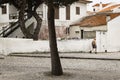 Nazare Sitio, Portugal - July 19 2019: A man walks down the .Praca da Republica, a typical rustic Portuguese street