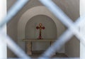 A cross with a crucifix stands on a table in an old chapel in the catholic Christian Transfiguration Church located on Mount Tavor