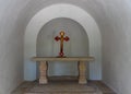 A cross with a crucifix stands on a table in an old chapel in the catholic Christian Transfiguration Church located on Mount Tavor