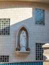A marble statue of the Virgin Mary with a baby in her hands stands in a niche in the wall of the house in the old part of Nazareth Royalty Free Stock Photo
