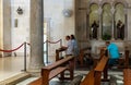 Believers pray on their knees in the main hall of the Saint Josephs Church is located on the territory of Church of the