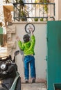 A drawing depicting a boy moving the hands of a clock is painted on the wall of a house of Nazareth old city in northern Israel