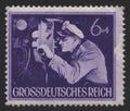 NAZI GERMANY - CIRCA 1944. Postage Stamp with nazi german submarine commander looks at the periscope U-boat. U-boat is an