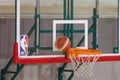 NBA logo on a backboard while a basketball is about to score on its ring. Royalty Free Stock Photo