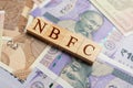 NBFC in wooden block letters on indian currency