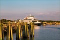 NC USA. Sun rise Pink clouds sky, reflections in water.Ferry at the pier