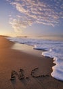 NC written in sand letters at sunrise on the beach in Oak Island North Carolina Royalty Free Stock Photo