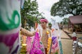 People pin traditional flags on sand pagoda