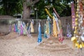 People pin traditional flags on sand pagoda