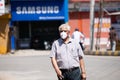 Indian aged Old man Wearing mask and on road Increasing the Risk of Corona virus