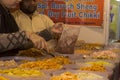 22nd December, 2021, Kolkata, West Bengal, India: A seller selling delicious Gujarati salty snacks items at Industrial trade fair