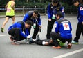 The 2nd International Marathon runner got a injury, volunteers helping stretching his feet