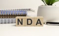 NDA Non Disclosure Agreement acronym on wooden cubes Royalty Free Stock Photo