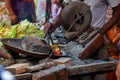 ndian man hands roasting corn, the indian street food at street market