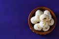 Indian Sweet or Dessert - Rasgulla, Famous Bengali sweet in clay bowl on Blue background