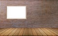 0ne large picture frames mounted on a red brick wall with wooden floors and space for the background Royalty Free Stock Photo