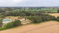 Neacroft, Dorset / United Kingdom - July 10, 2019:An aerial view of a traditional farm with tatch roof under renovation along a