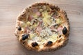 Neapolitan pizza with ham, mushrooms and cheese. Baked edges in a wood-fired oven Royalty Free Stock Photo