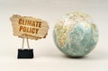 Near the globe there is a clip with a cardboard plate on which it is written - climate policy