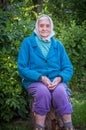 Near one hundred year woman sitting outdoors