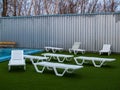 White plastic chaise lounges stand near the pool with hot thermal water